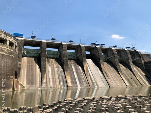 dam building that stands firmly accompanied by rocks under the river flow to reduce heavy water. photo