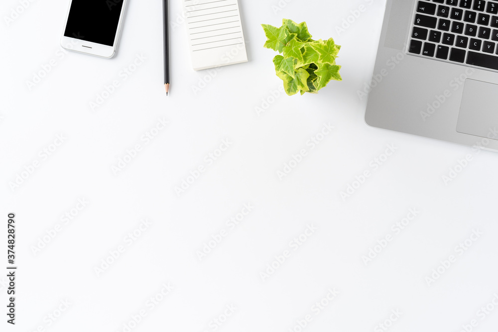 Overhead shot of modern workspace concept with laptop and business accessories on white background with copyspace. Office desktop. Flat lay Overhead shot of modern workspace concept with laptop and business accessories on white background with copyspace. Office desktop. Flat lay