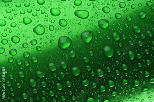 Green aluminum can with water drops close-up macro shot.