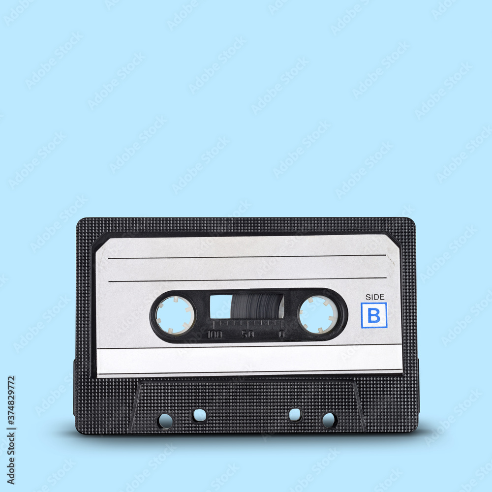Old audio tape cassette on blue background