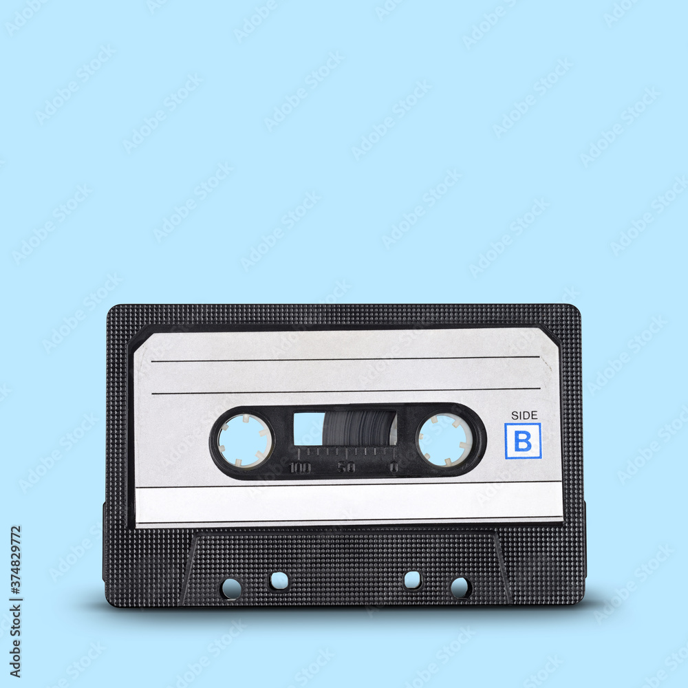 Obraz premium Old audio tape cassette on blue background