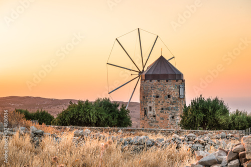 Old windmill at sunset, landscapes and mountains of Crete island