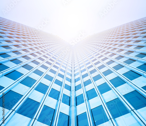 looking up view of skyscrapers reflect blue sky