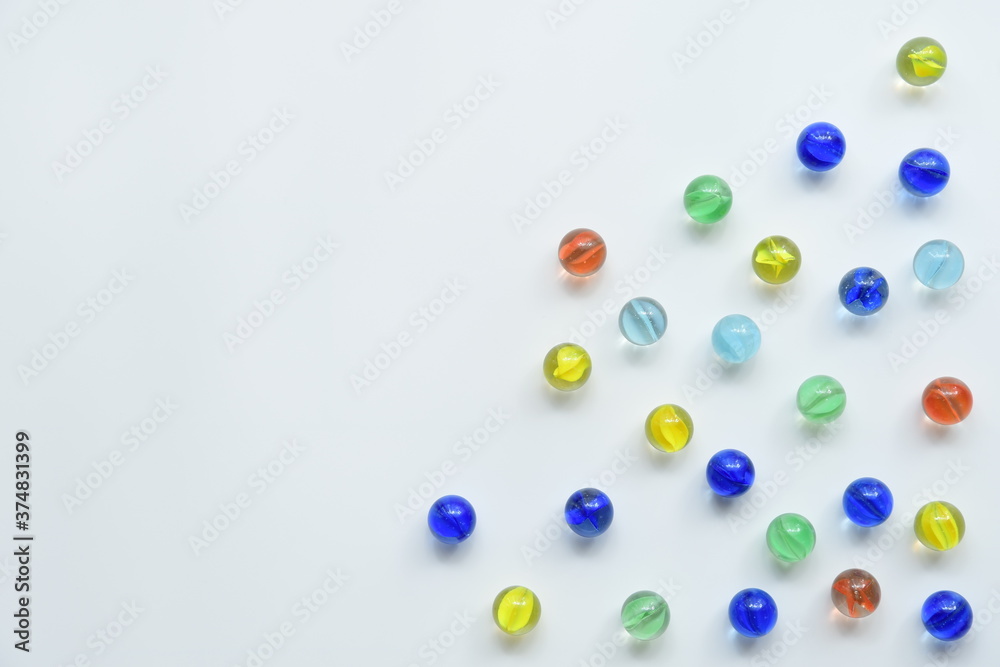 Colorful glass marbles on white background.