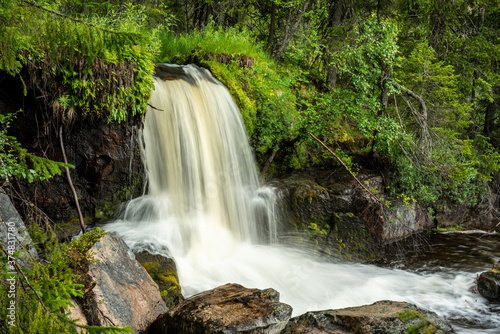 Small waterfall in the middle of a forest in Sweden