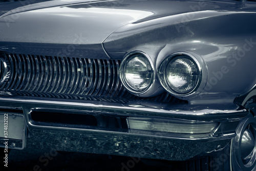 Partial view of a beautiful silver colored vintage car from the fifties photo