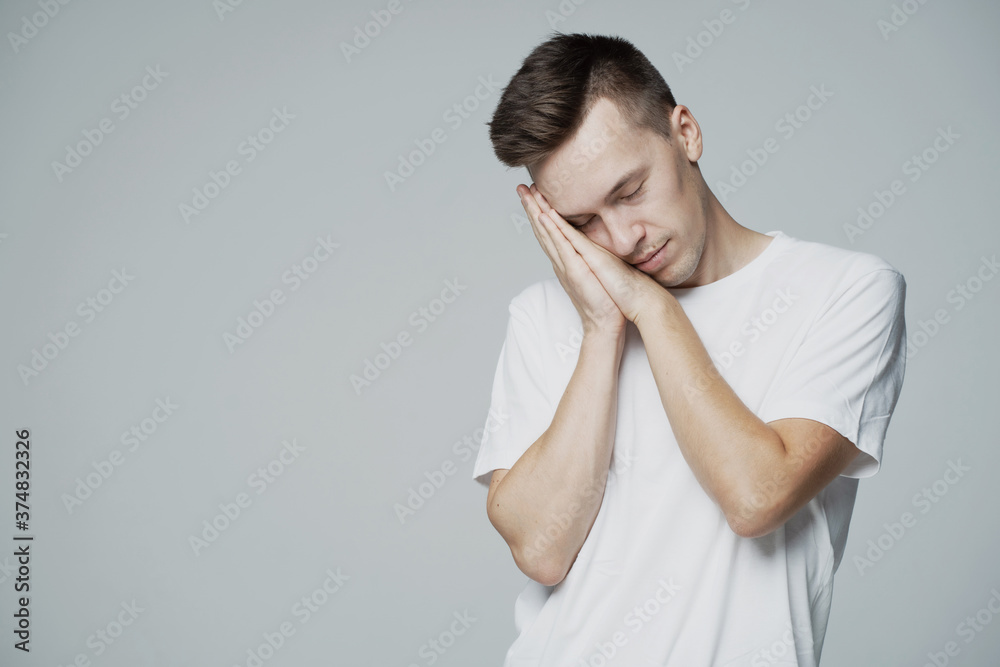 lazy male student is fast asleep, Vidlitsa rumpled sleepy. dream. white t-shirt and grey background. place a banner ad for a company lazy male student is fast asleep, Vidlitsa rumpled sleepy. dream. white t-shirt and grey background. place a banner ad for a company