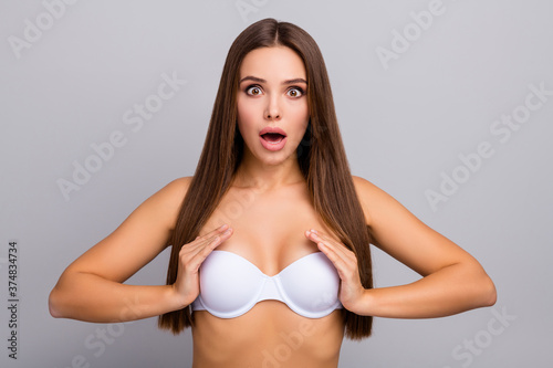 Close-up portrait of her she nice-looking attractive lovely pretty healthy amazed cheerful cheery straight-haired girl wearing touching white bra isolated over gray pastel color background