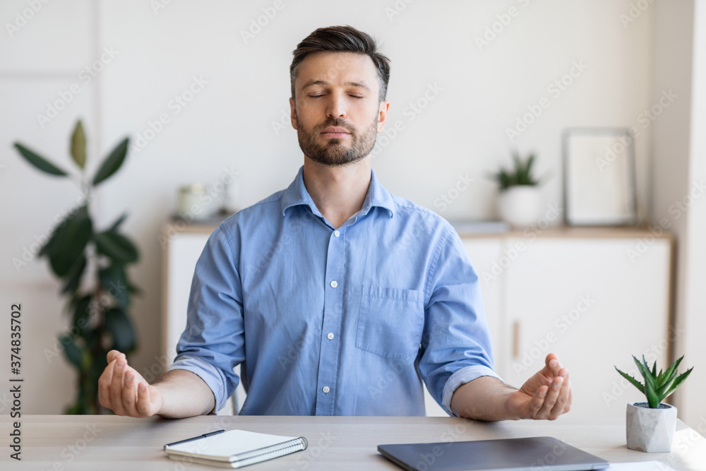 Office Zen. Relaxed Male Entrepreneur Meditating At Workplace, Coping With Work Stress - obrazy, fototapety, plakaty 
