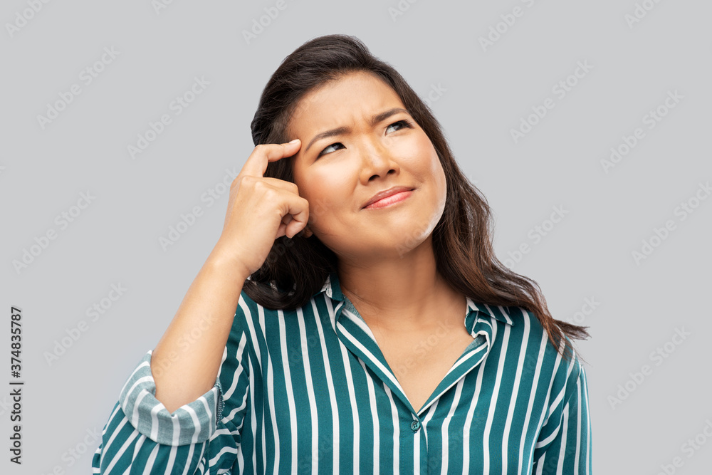 idea, solution and decision concept - thinking asian young woman over grey background idea, solution and decision concept - thinking asian young woman over grey background
