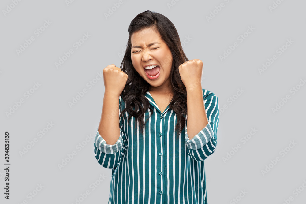 people, gesture and winning concept - happy asian young woman celebrating success over grey background people, gesture and winning concept - happy asian young woman celebrating success over grey background