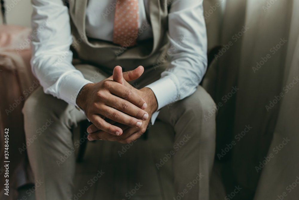 Obraz premium close up of man hands with suit and tie, sitting. Meditation concept, groom or businessman.
