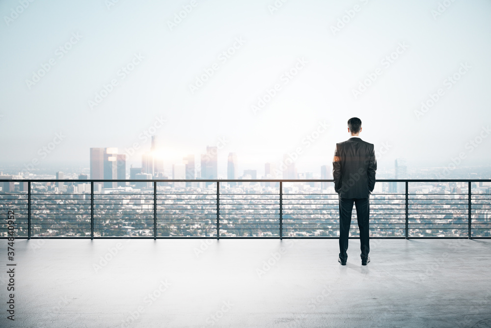 Man standing on roofrop with panoramic New York city view