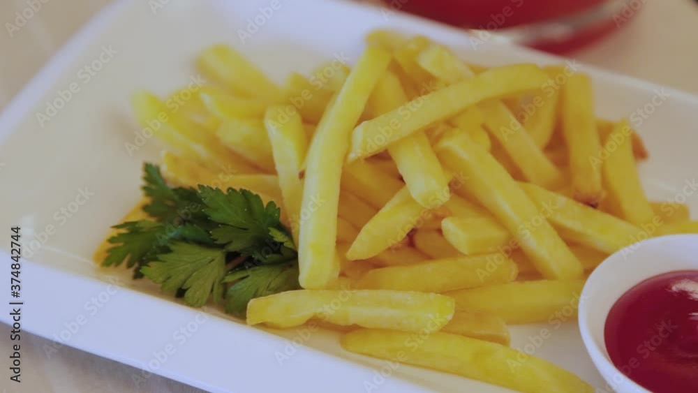 Yellow crispy fried potatoes with sauce on a plate. Yellow crispy fried potatoes with sauce on a plate.