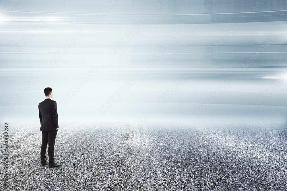 Businessman on empty asphalt road and looking at horizon. Find the way concept
