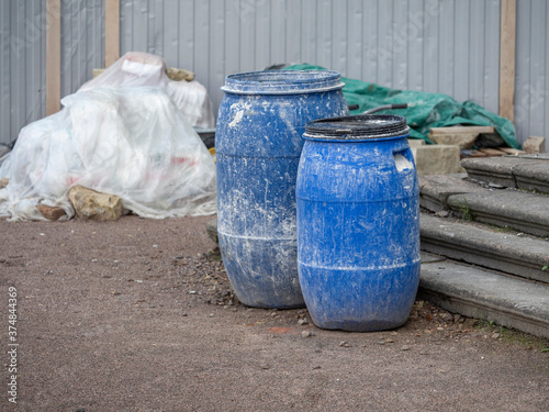 Plastic blue barrels on the construction site