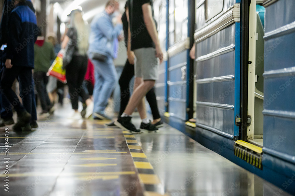 People get off the train car in the subway People get off the train car in the subway
