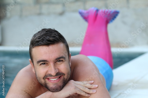 Handsome merman in swimming pool 
 photo