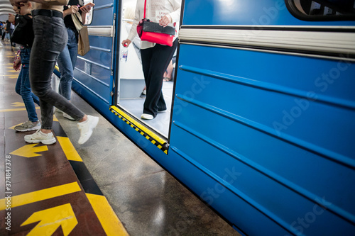 People get off the train car in the subway