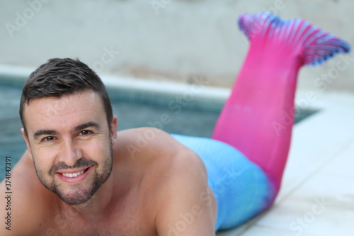 Handsome merman in swimming pool 
 photo