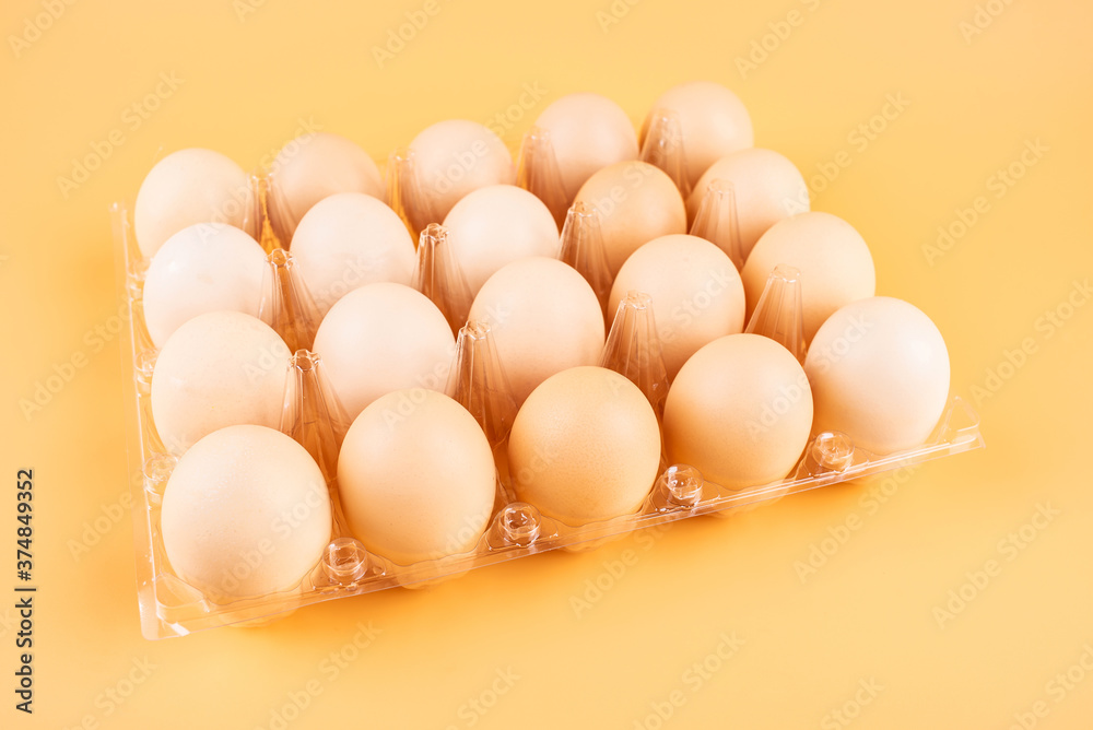 Eggs in a plate on yellow background