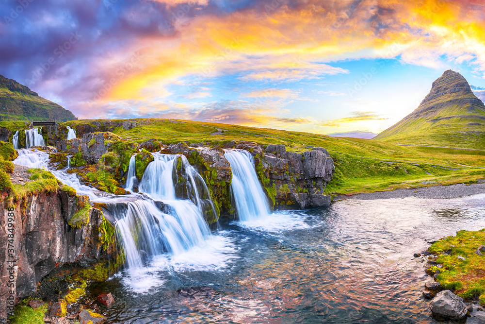 Fantastic view on Kirkjufellsfoss waterfall  near Kirkjufell mountain at sunset - obrazy, fototapety, plakaty 