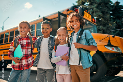 Children near school bus photo