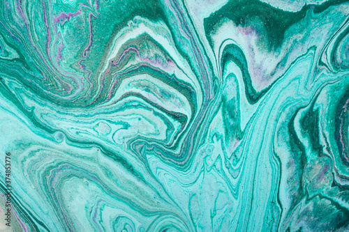 Modern fluid art. Abstract colorful background with swirl of acrylic pouring paints.