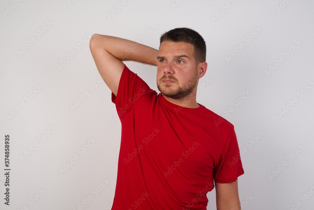Beautiful businessman wearing casual shirt over isolated yellow background confuse and wonder about question. Uncertain with doubt, thinking with hand on head. Pensive concept. Beautiful businessman wearing casual shirt over isolated yellow background confuse and wonder about question. Uncertain with doubt, thinking with hand on head. Pensive concept.