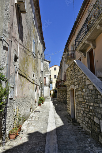 Fototapeta Naklejka Na Ścianę i Meble -  A narrow street among the old houses of Santa Croce del Sannio, a medieval village in the Campania region.
