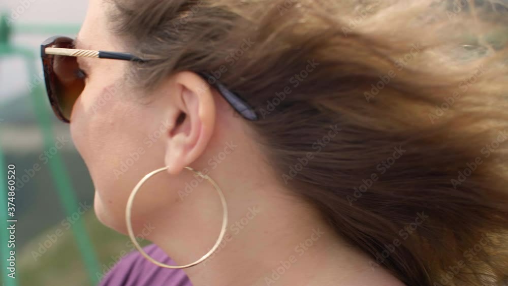 Woman in sunglasses turning head and photographing landscape with smartphone. Close-up view of beautiful young woman taking pictures on scenic seascape with mobile phone Woman in sunglasses turning head and photographing landscape with smartphone. Close-up view of beautiful young woman taking pictures on scenic seascape with mobile phone