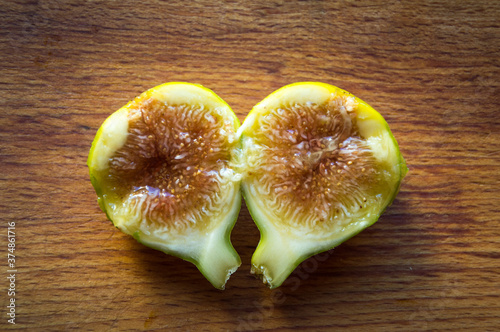 Fresh cut fig on a wooden board