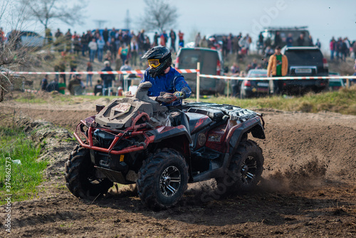 Active ATV and UTV riding in the mud at sunny day