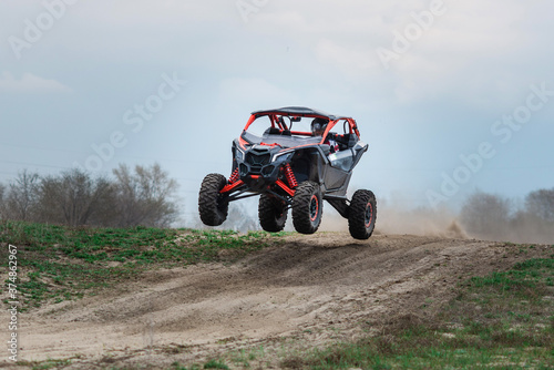 UTV buggy in the action on sand in summer photo