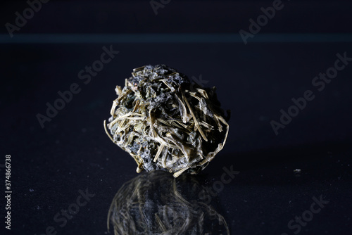 Tea ball on a glass table photo