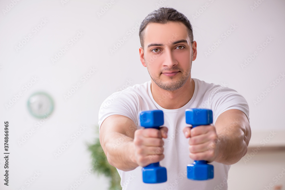 Young male starting day with morning exercises