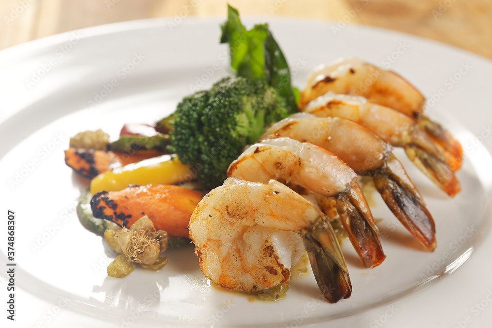 Grilled shrimp with bell pepper, pumpkin, carrot, and broccoli. Grilled shrimp with bell pepper, pumpkin, carrot, and broccoli.