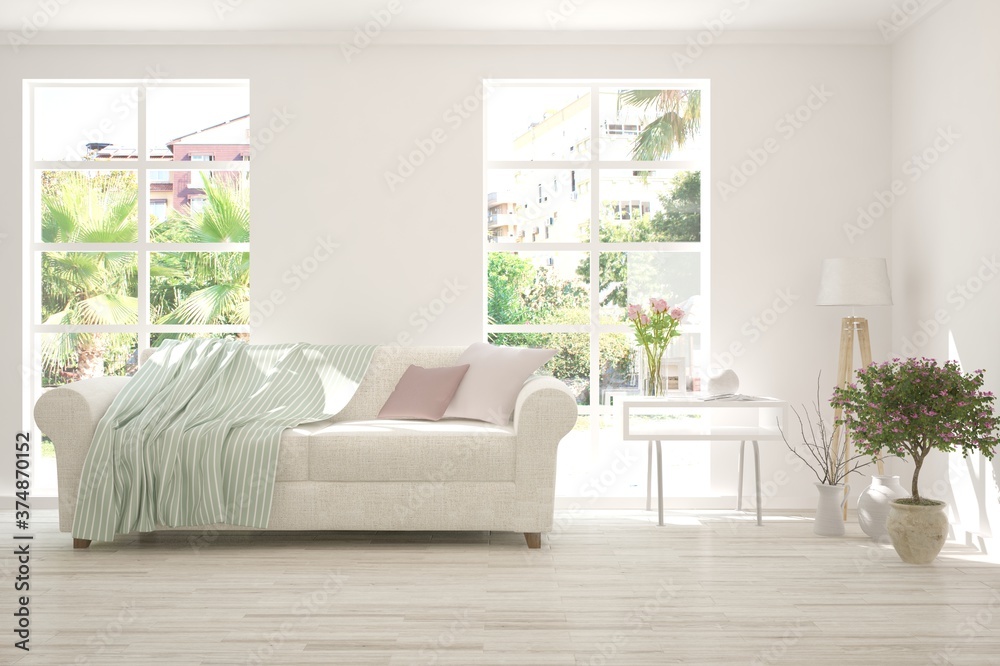 Fototapeta premium White living room with sofa and summer landscape in window. Scandinavian interior design. 3D illustration