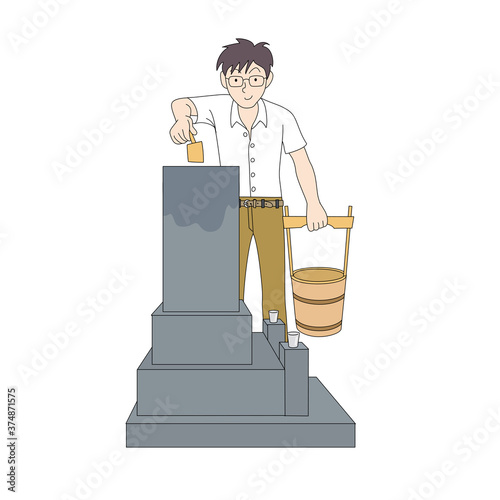 墓に水をかけるお父さん