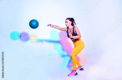 Fototapeta Naklejka Na Ścianę i Meble -  Woman training with the exercizes ball in the gym