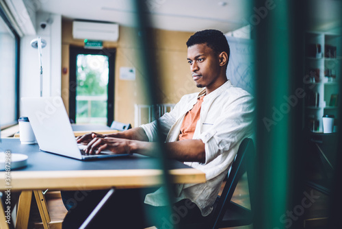Smart black man browsing laptop