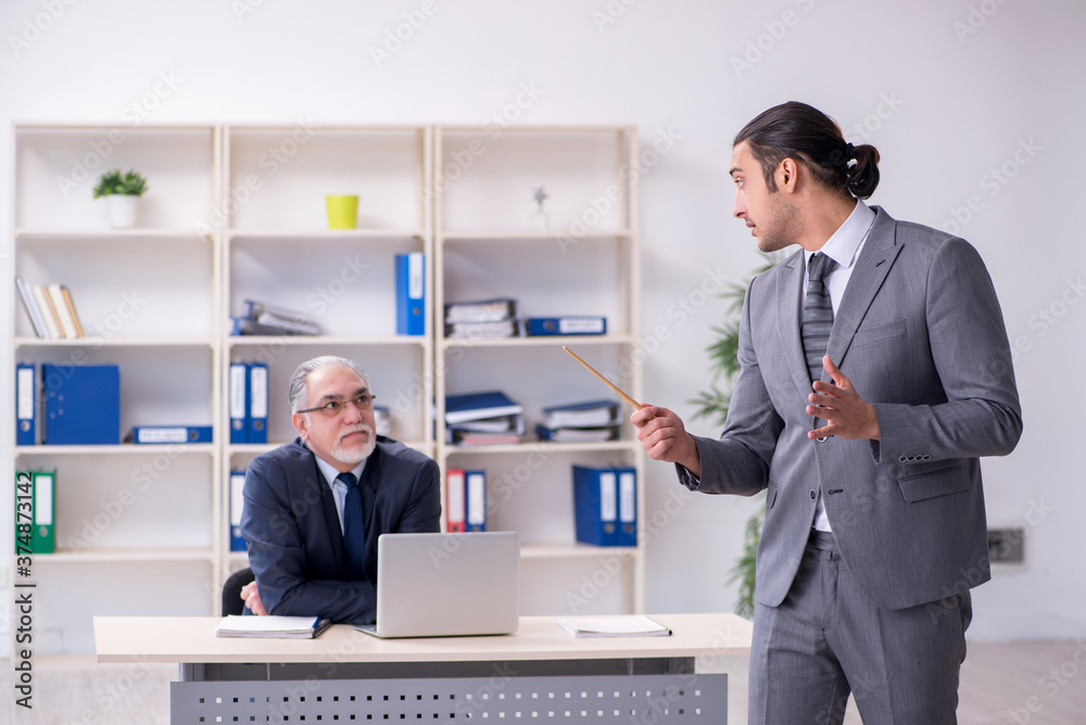 Old and young businessmen in business meeting concept