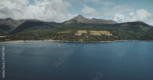 Scotland's ocean bay scenery aerial panoramic view from Goat fell, Brodick Harbour, Arran Island. Majestic Scottish landscape of mountain: forests, meadows and medieval castle shot