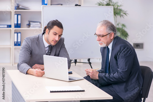 Old and young businessmen in business meeting concept