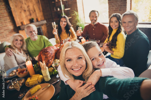 Self-portrait of nice attractive cheerful big full family brother sister gathering having fun boy embracing mom celebratory autumn occasion at modern loft brick industrial interior