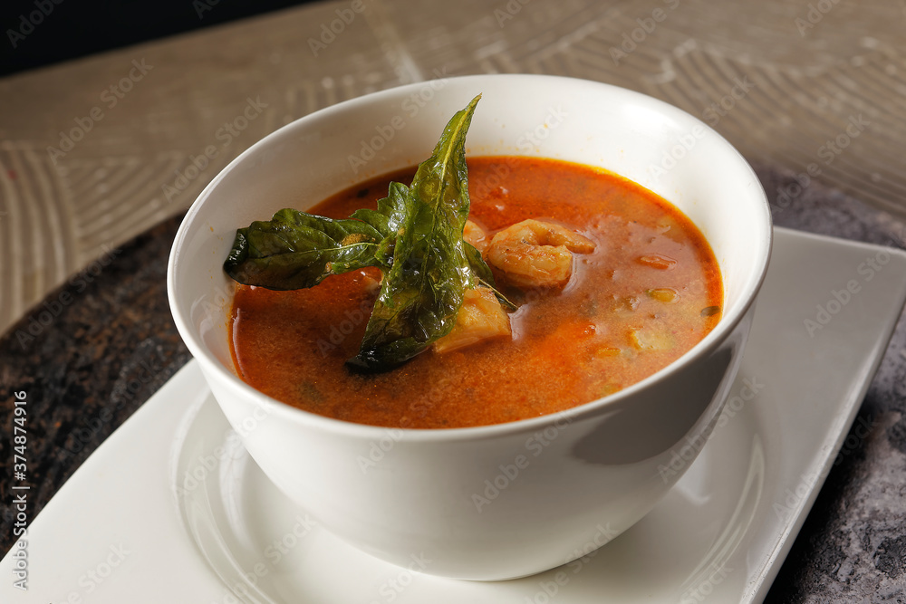 Shrimp broth and fish fillet with vegetables.