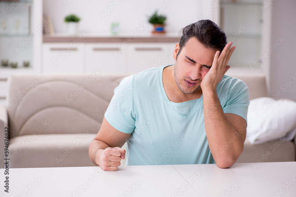 Fototapeta premium Young man suffering from toothache