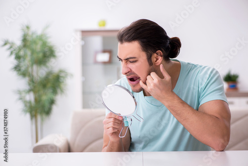 Young man suffering from toothache photo