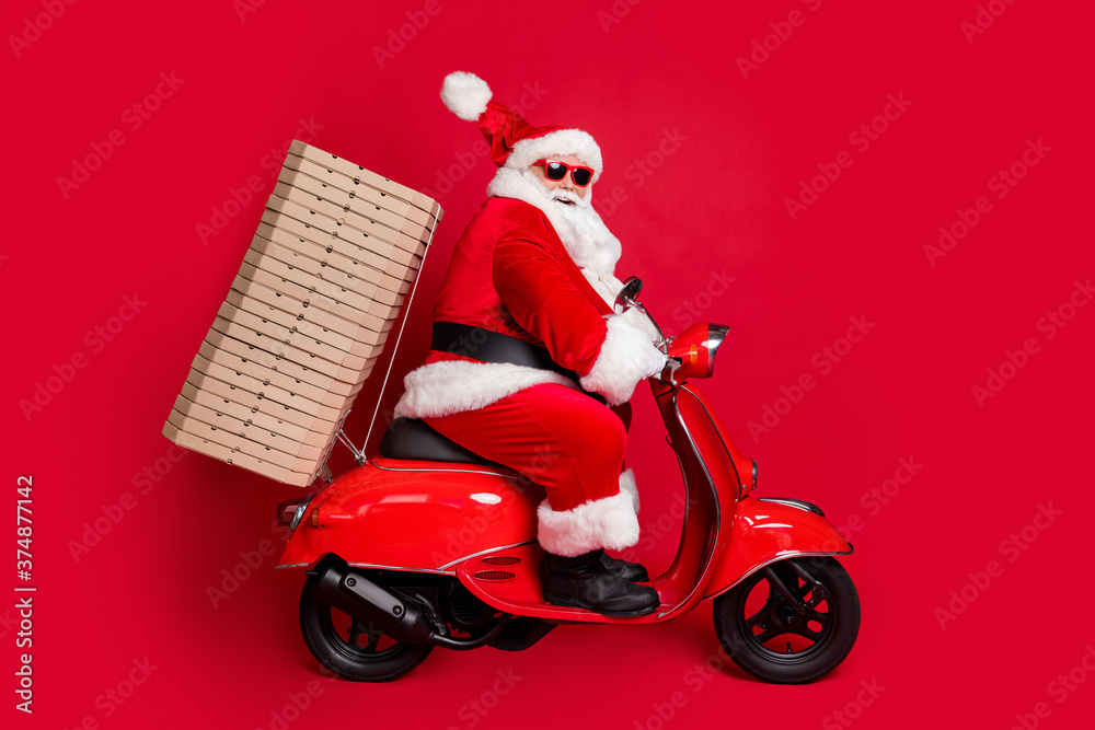 Full length profile photo of retired grandpa white beard ride pizza boxes support sponsoring newyear event wear santa x-mas costume coat sunglass cap boots isolated red color background Full length profile photo of retired grandpa white beard ride pizza boxes support sponsoring newyear event wear santa x-mas costume coat sunglass cap boots isolated red color background