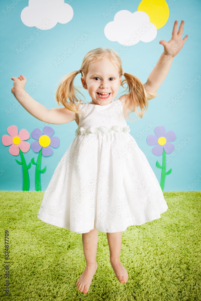 Happy Little Girl Jumping with Excitement in Imaginary Outside Wonderland World Happy Little Girl Jumping with Excitement in Imaginary Outside Wonderland World